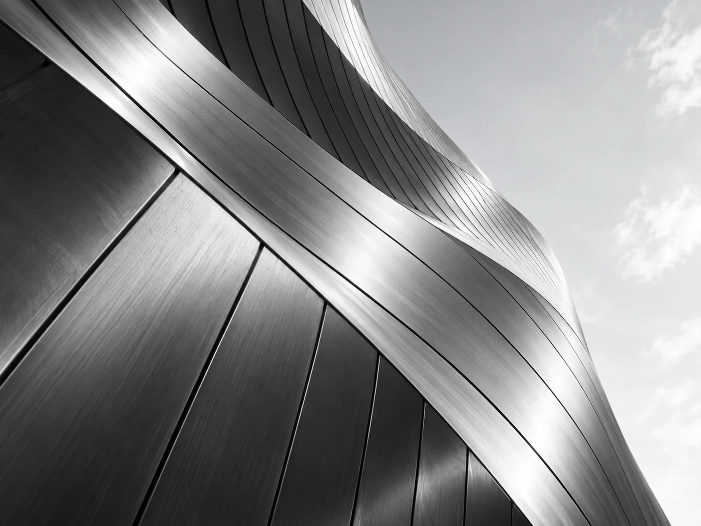 Abstract architectural study of a curved metal facade